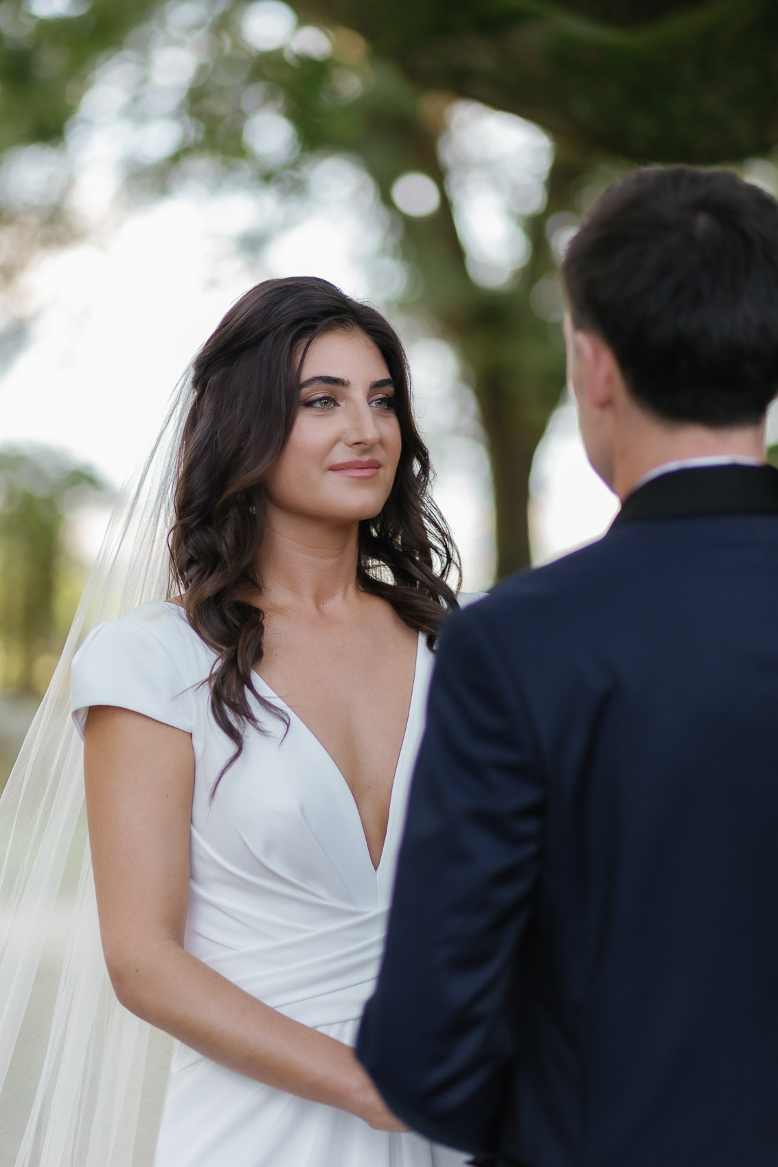 Athena and Jesse exchanging vows under the magical tree at Château de Fey Wedding