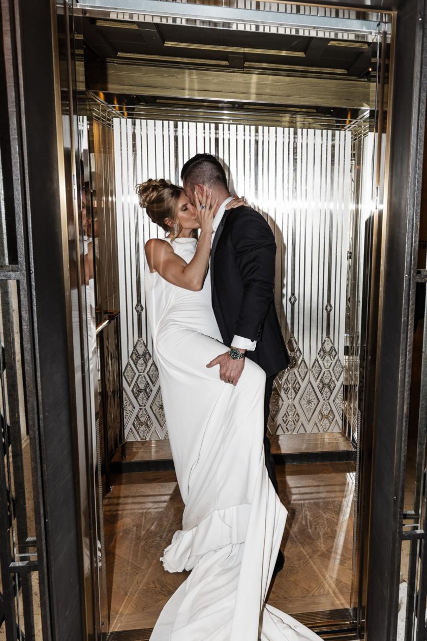 Modern bride and groom sharing an intimate kiss in a luxury Paris hotel elevator, captured by Olivier Neuville Photography.