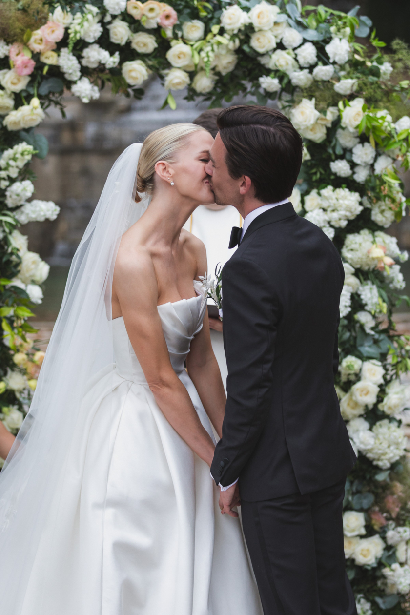 omantic wedding kiss captured in an elegant floral ceremony in Paris by destination photographer Olivier Neuville.