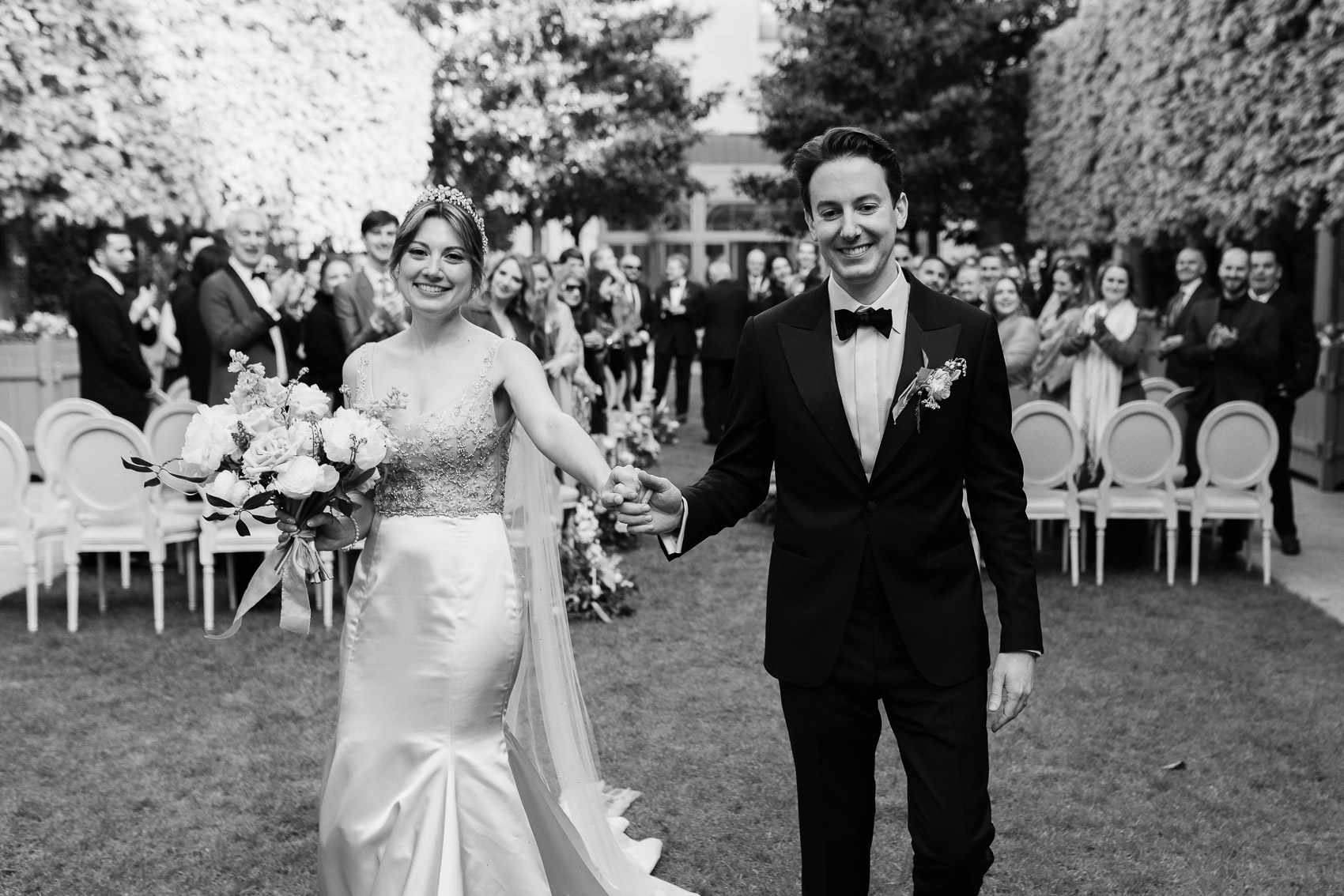 Exit from the ceremony into the Ritz Paris garden, a beautiful transition to outdoor celebration