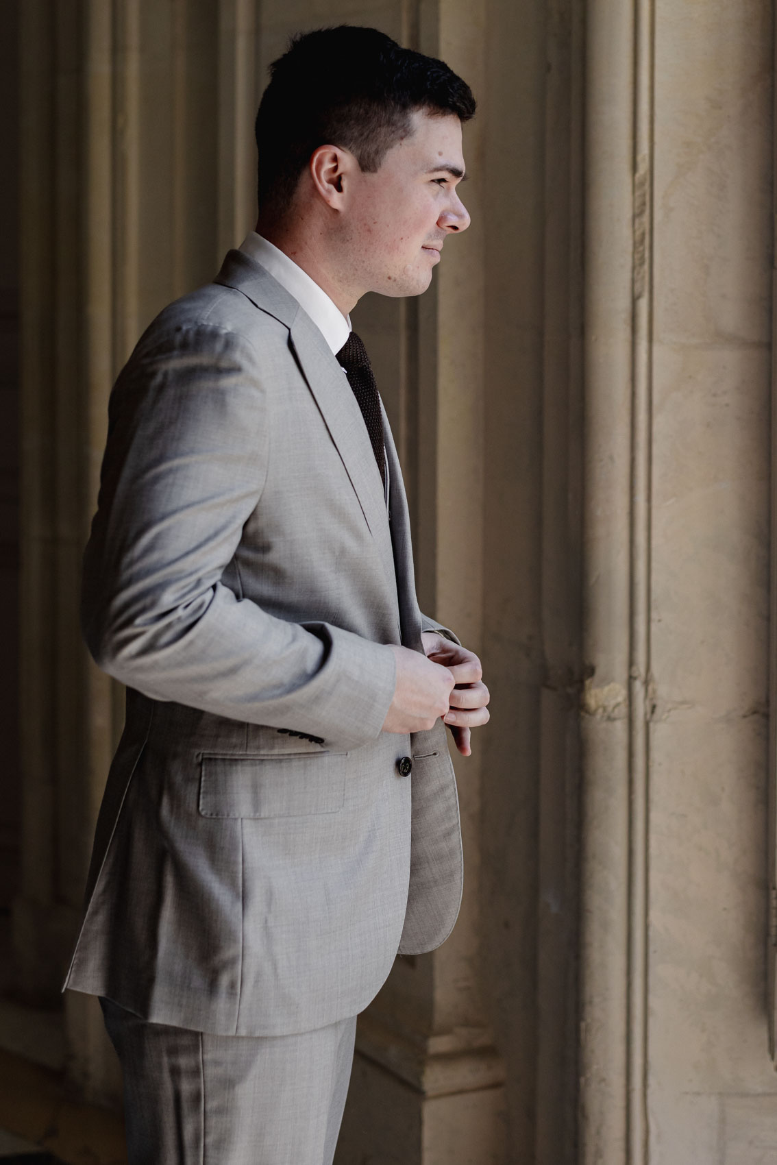 Groom exuding sophistication at Château de Champlâtreux.